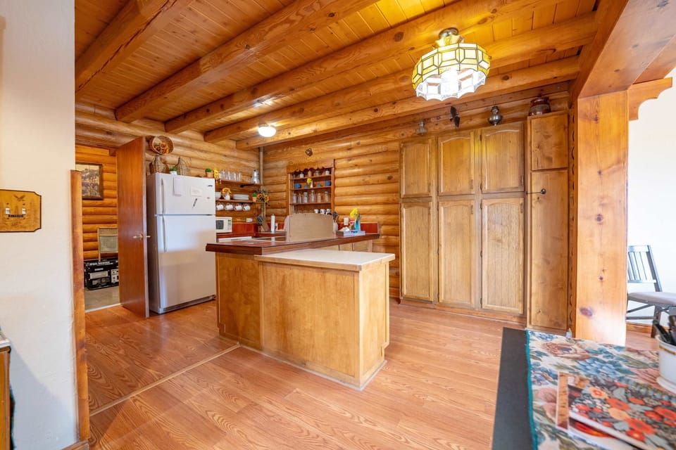 The ktichen is fully stocked with the dining area just off of it.
