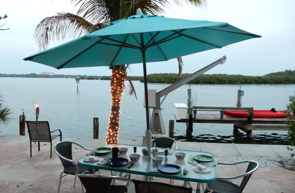 Patio with outdoor eating area.  Grill is to the right.