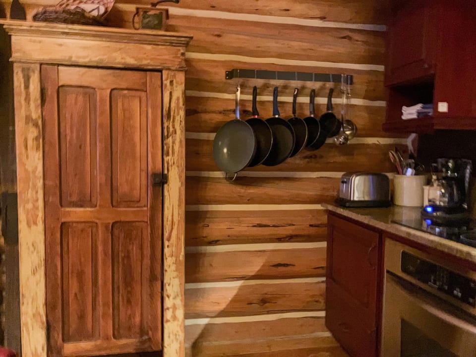 Kitchen is fully stocked with pots, pans, spices, and other pantry essentials.