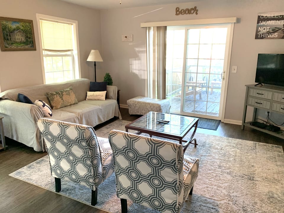 Family Room open to dining room and kitchen with access to the outdoor deck.