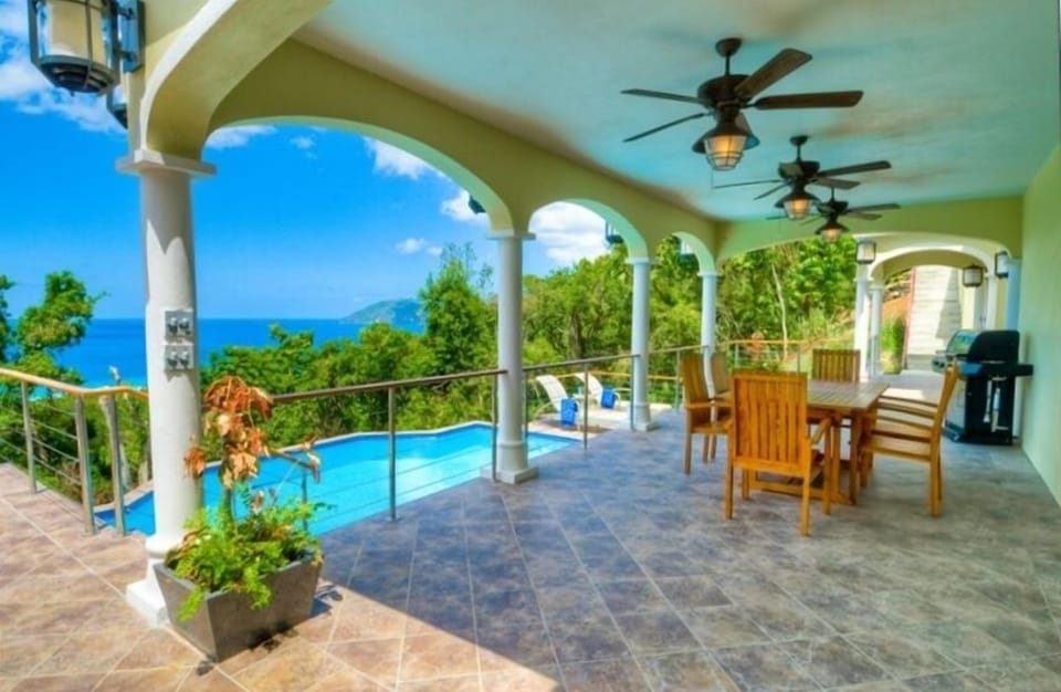 Pool level grilling and dining area has wet bar and lower level kitchenette