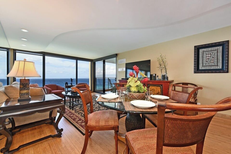 Enjoy meals in a stylish dining space with large windows framing breathtaking ocean views
