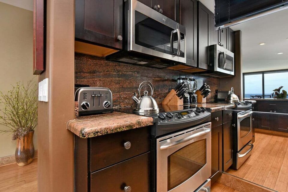 Cook with ease in a kitchen designed for convenience, featuring a stainless steel oven and microwave