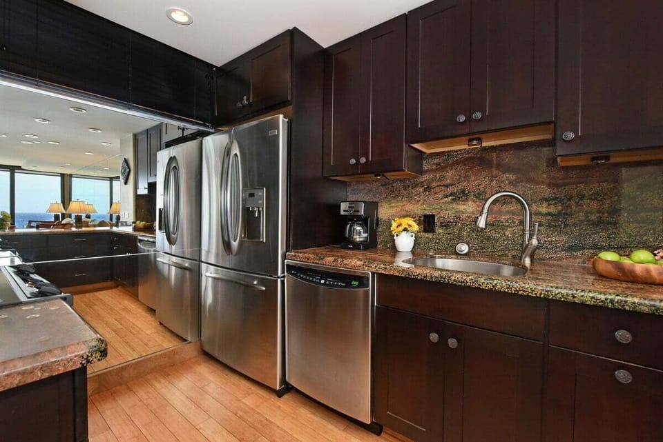 Enjoy a fully equipped kitchen with sleek granite surfaces, ample storage, and a stainless steel appliances