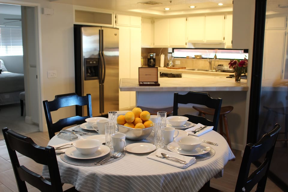 Dining table and kitchen view.  Dining table has leaf (not shown) and seats 6.