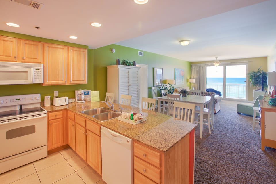 Fully stocked kitchen with spacious  countertop and bar seating.
