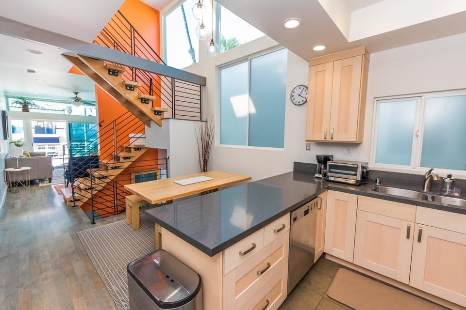 The cook's view toward the dining, living and ocean view balcony areas. Main middle level.
                