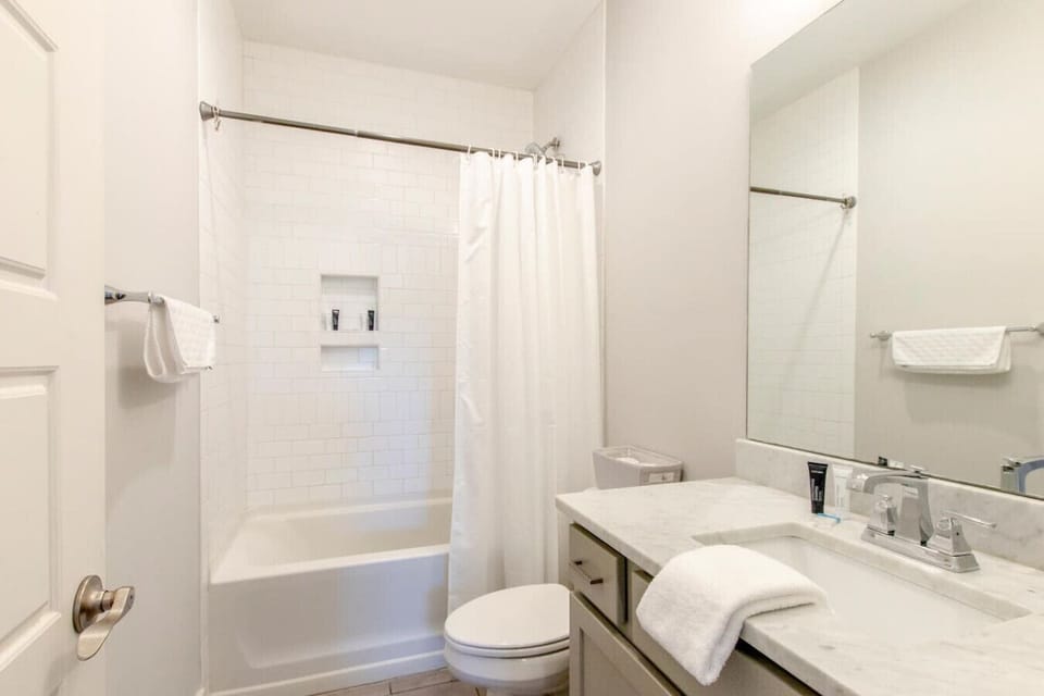A bathroom detail shows the clean vanity and organized setup that greets every guest.