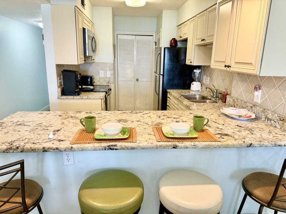Granite counter tops and bar stools have extra eating space for up to 4.