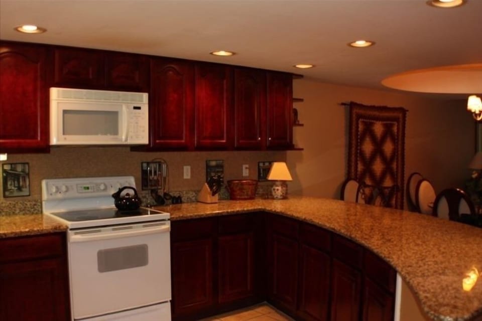 Cherry cabinetry and beautiful granite counters.
