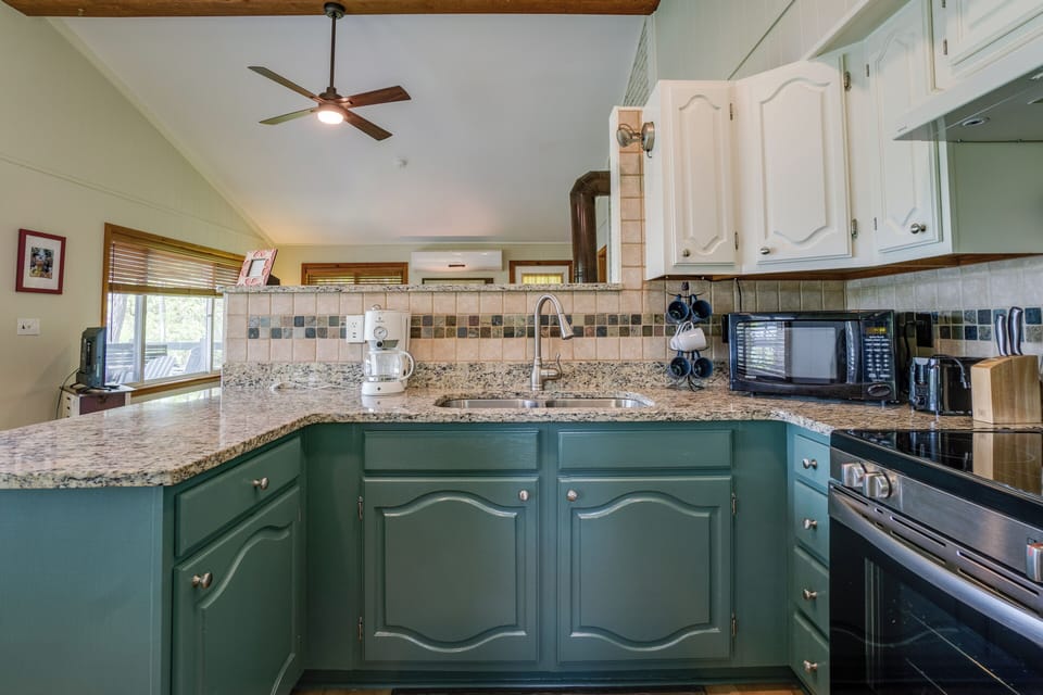 Kitchen looking toward living room. Vaulted ceilings.