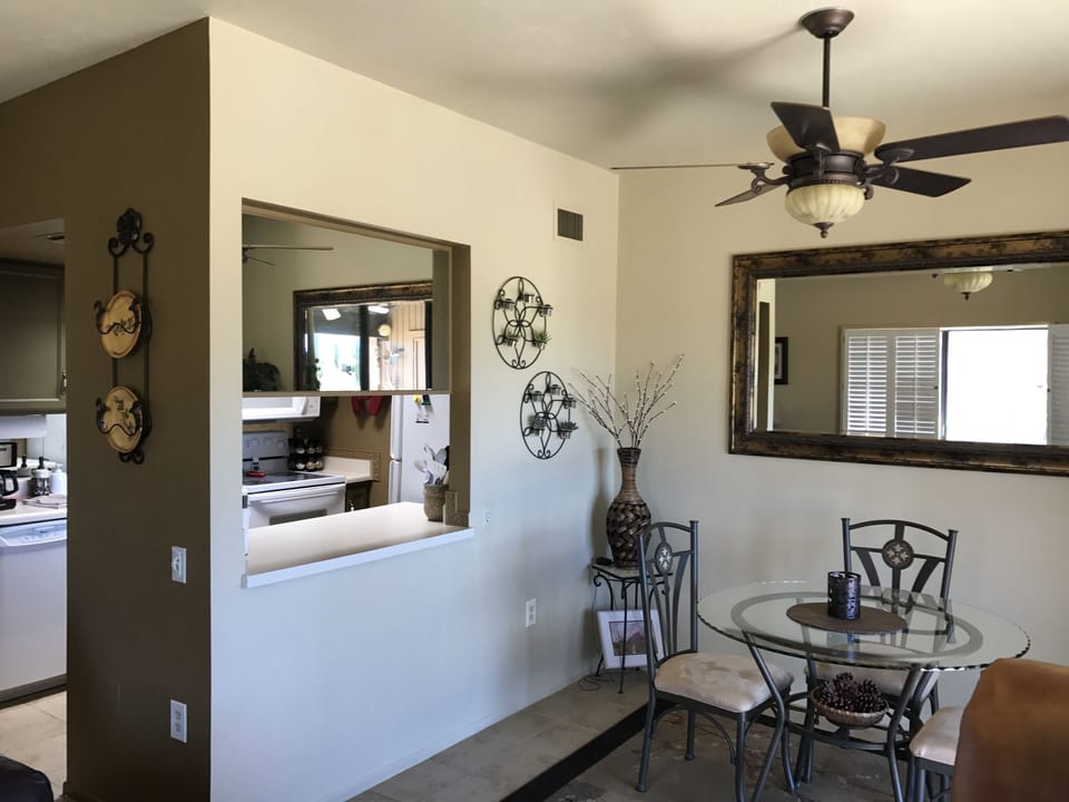 The inside dining room with a window opening into the kitchen!