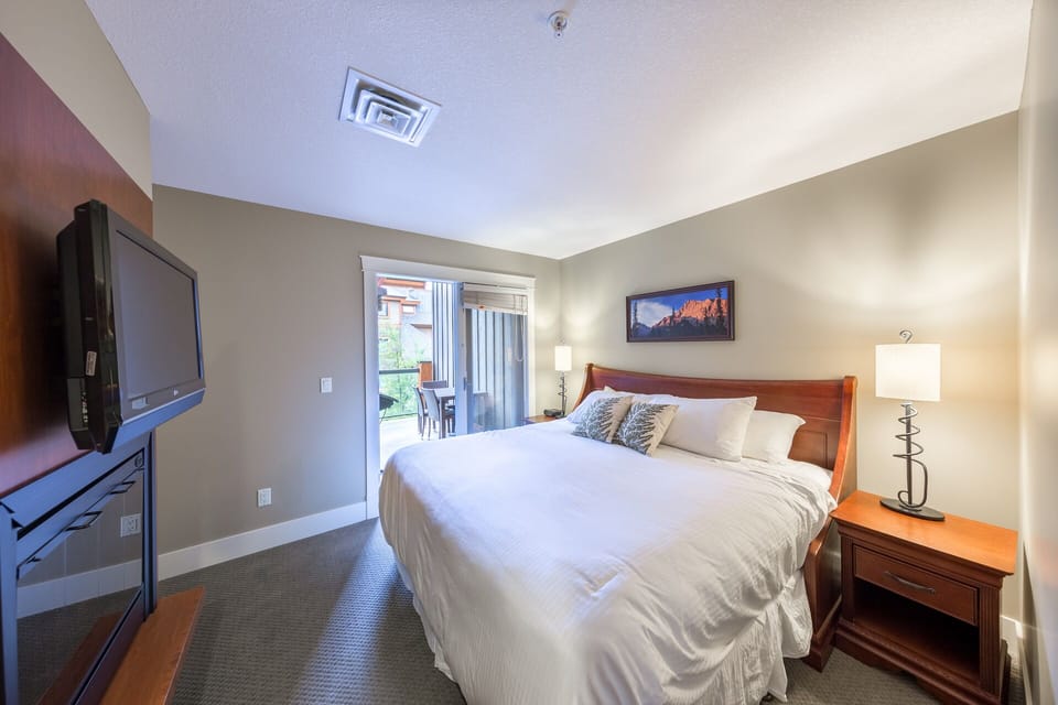 King bedroom with access to patio and private en-suite bathroom