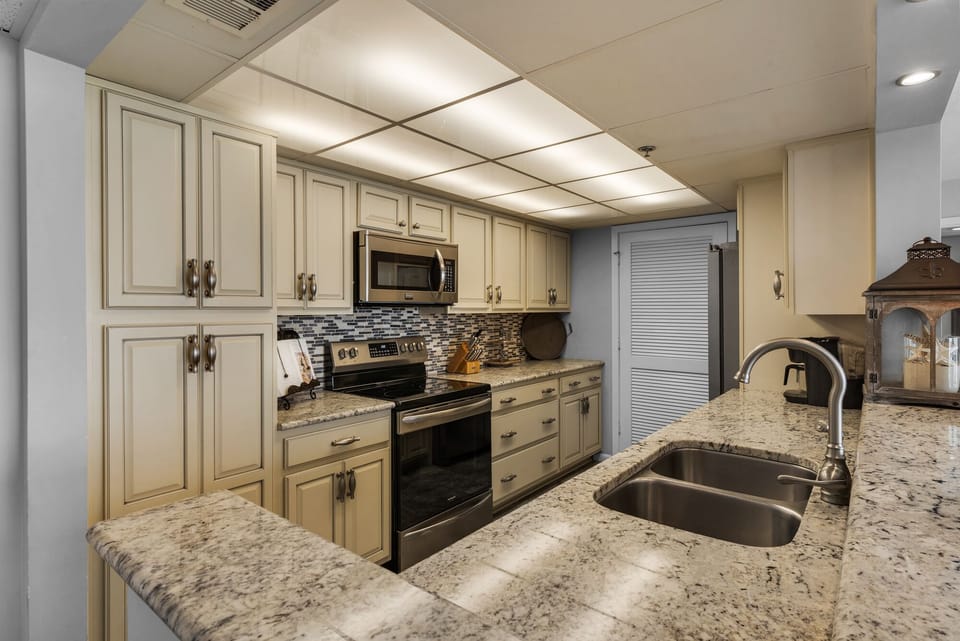 Luxurious kitchen with granite counters, stainless appliances, custom cabinetry