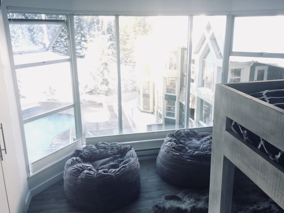 Second bedroom with stunning bay windows overseeing the pool and ski slope