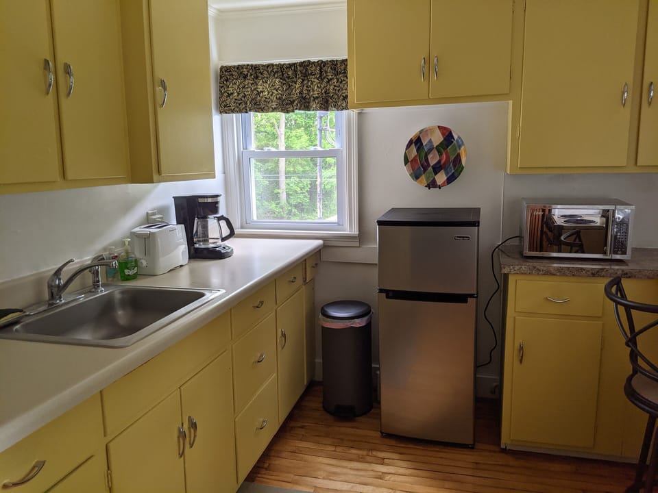 Kitchen with refrigerator, microwave, coffeemaker, toaster