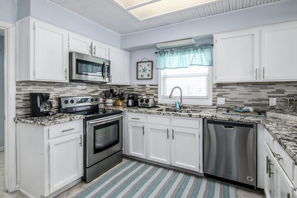 This Beautifully Updated Kitchen has Granite Counters and Gorgeous Backsplash