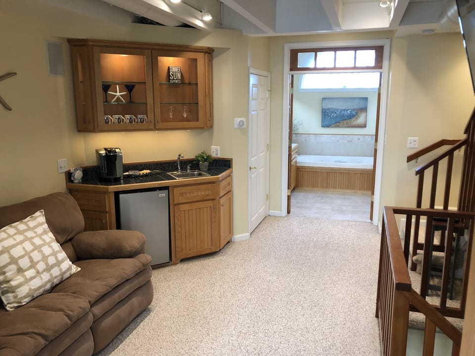 Sitting room off masterbedroom with wet  bar, coffee maker and TV