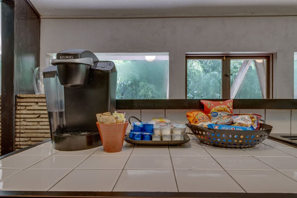 The kitchen has a Keurig coffee maker, stocked with coffee and treats!