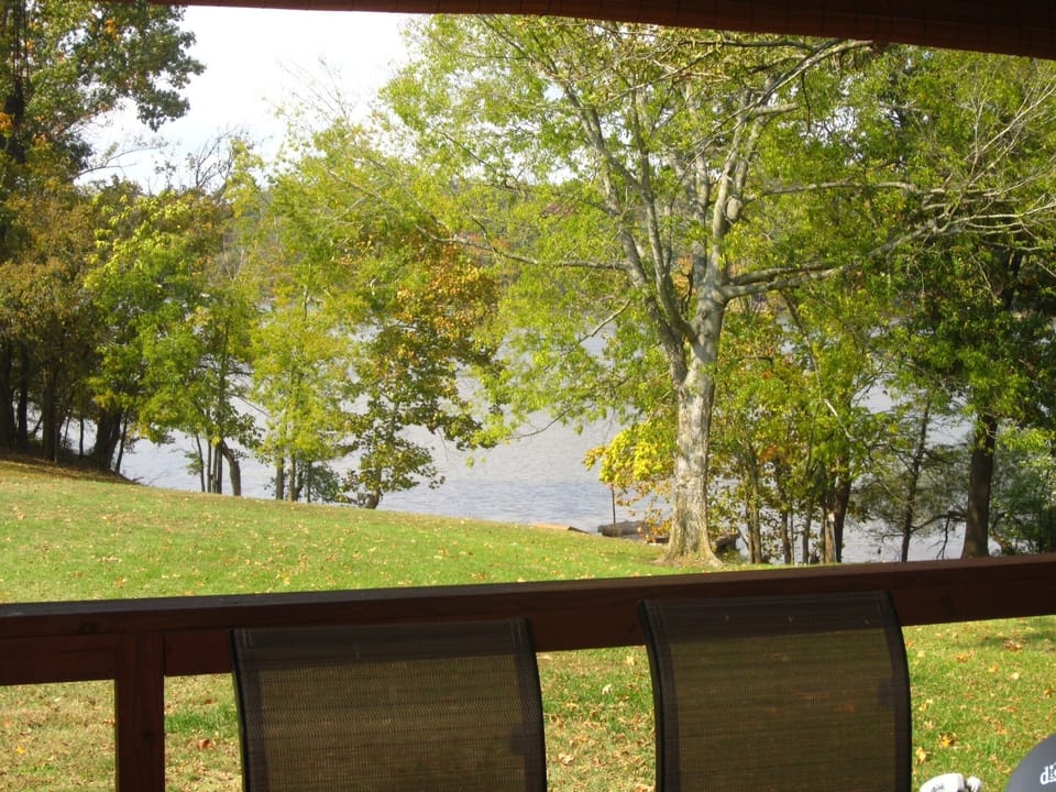 A view of our open, back lawn & the lake/ dock from the deck.