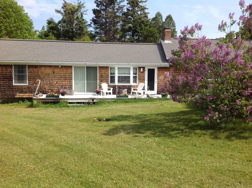 Settle & relax on the deck,  flagstone patio, or 'round the fire pit--