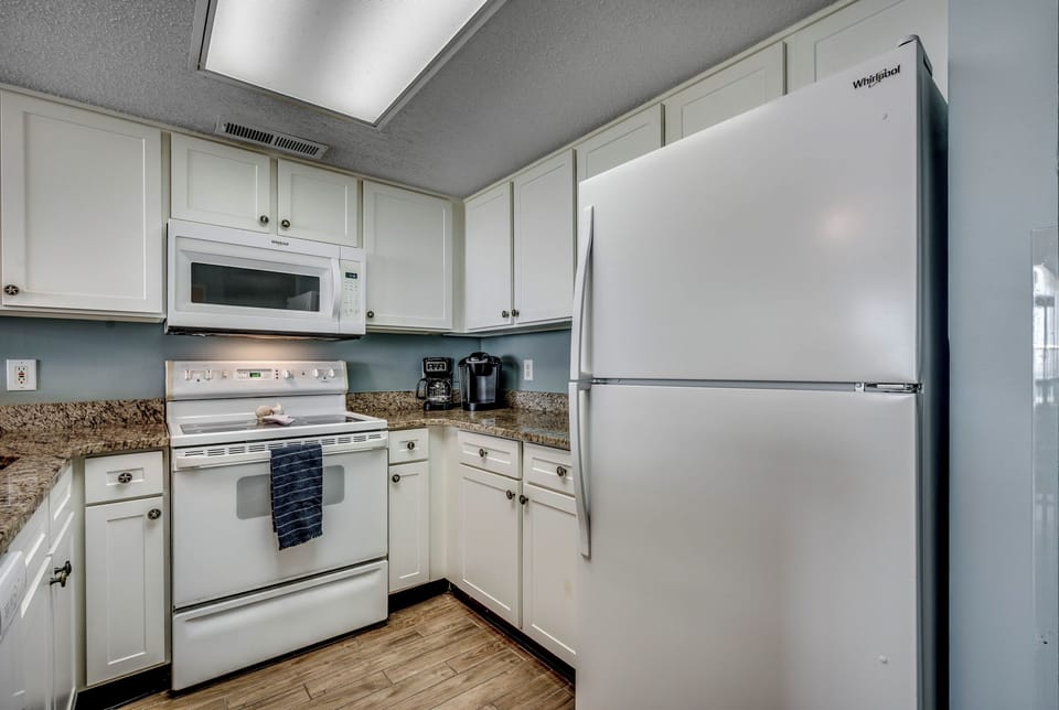 Updated kitchen with flat top stove, microwave, full size fridge and dishwasher