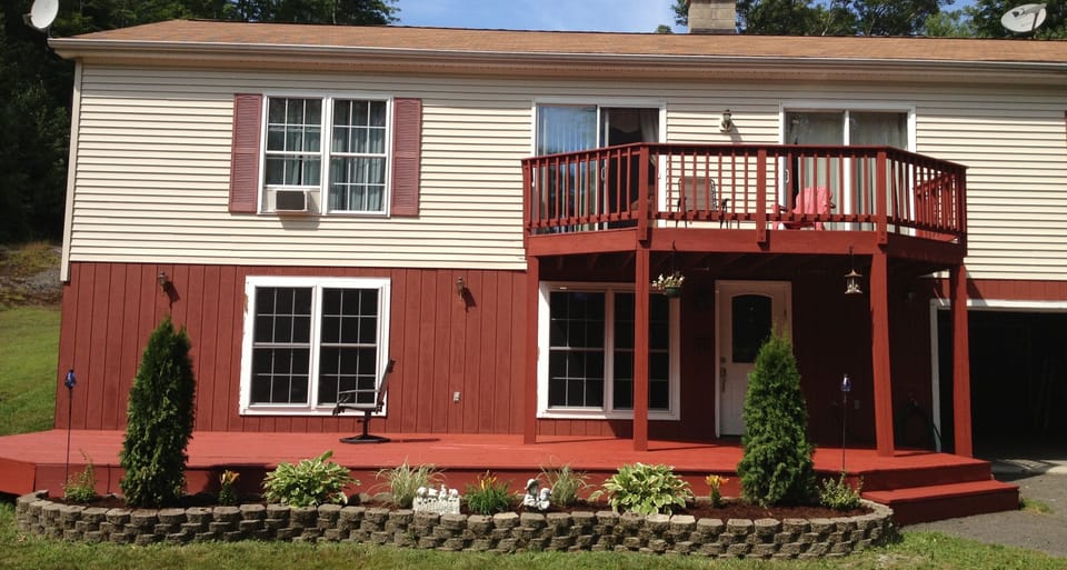 Our mountain house showing downstairs and upstairs front decks and garage