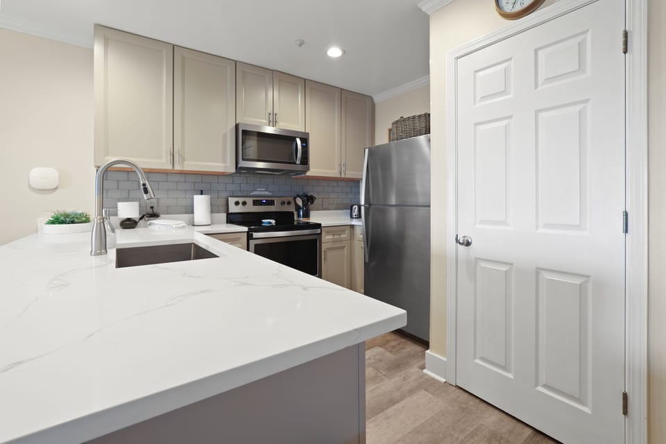 Newly updated kitchen with brand new countertop and stainless steel appliances
