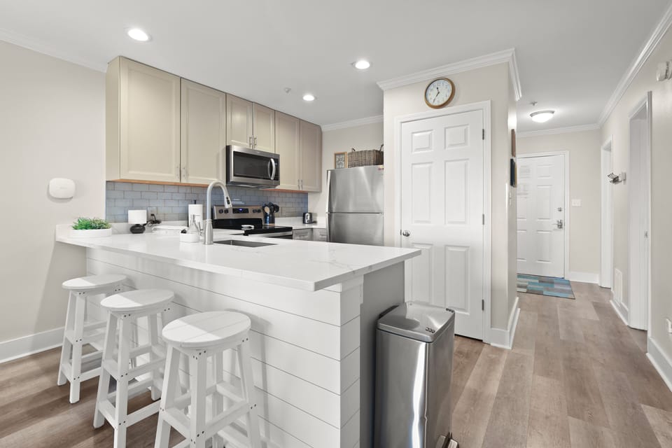 There is additional seating for guests on the kitchen bar