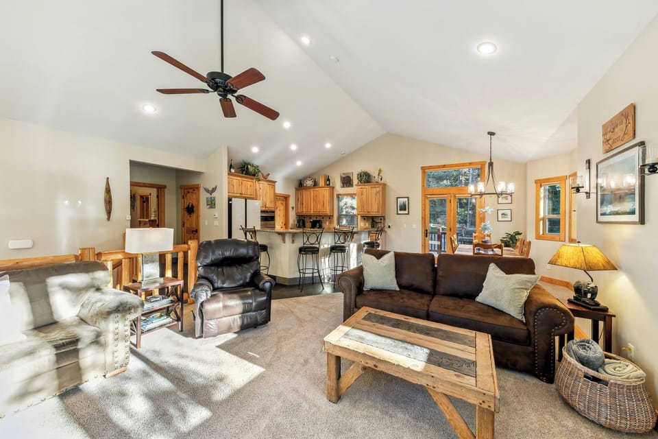 Unwind in this spacious open-concept living area where rustic charm meets modern comfort. Your mountain getaway features vaulted ceilings and warm wood accents.