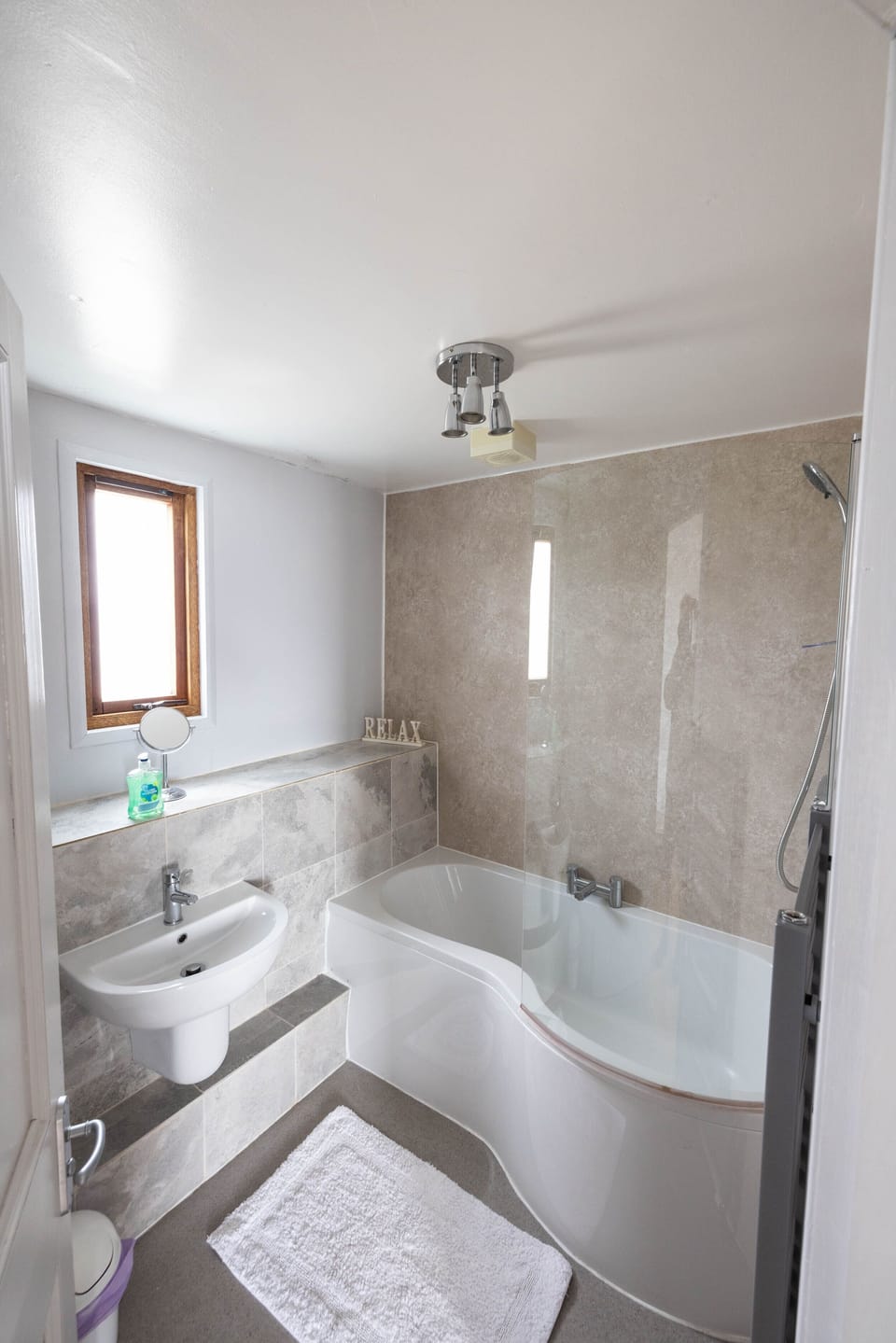 Ensuite to master bedroom with large double-ended bath and shower above.