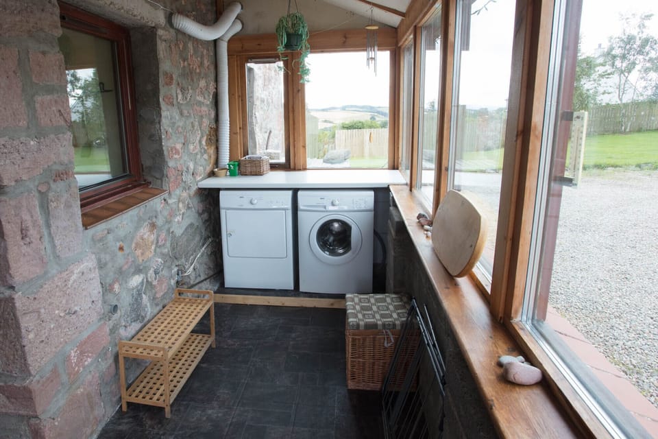 The entrance porch with washing machine and tumble drier