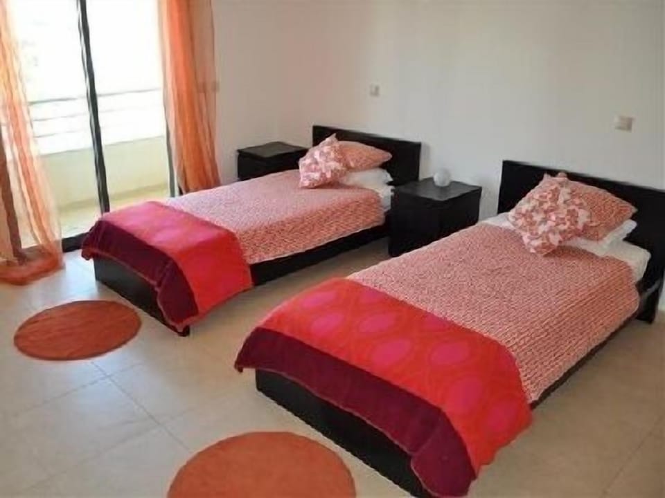 Twin bedroom with balcony overlooking the front of the apartment