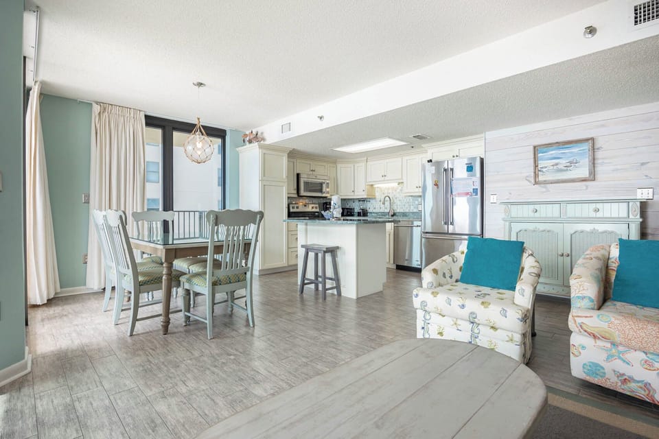 Gather around the dining table or relax in the inviting seating area, enjoying the bright, open layout of this space