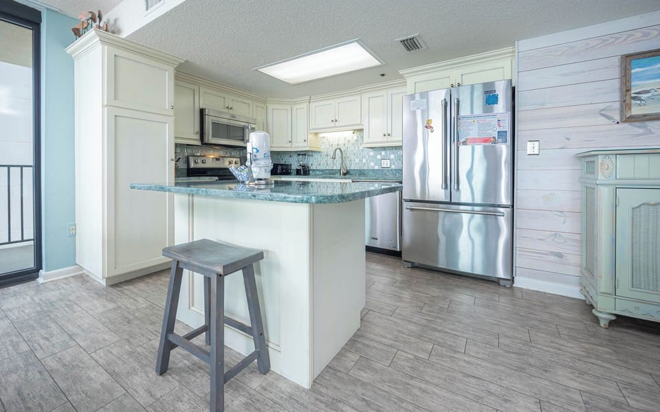 Enjoy preparing meals in this stylish kitchen with an island and stainless appliances, perfect for family gatherings