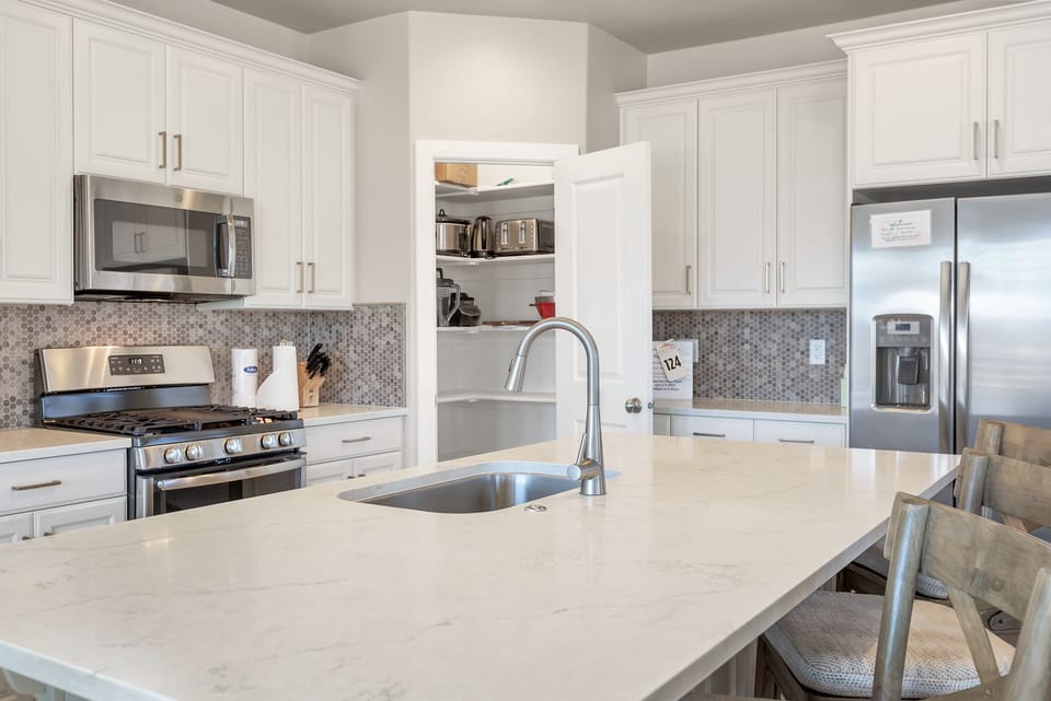Fully stocked gourmet kitchen featuring top of the line appliances