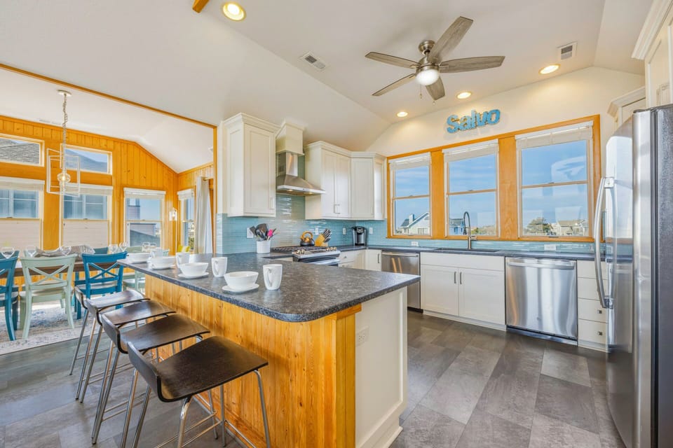 Your spacious kitchen awaits with granite counters, stainless appliances, and island seating perfect for morning coffee or casual meals together.