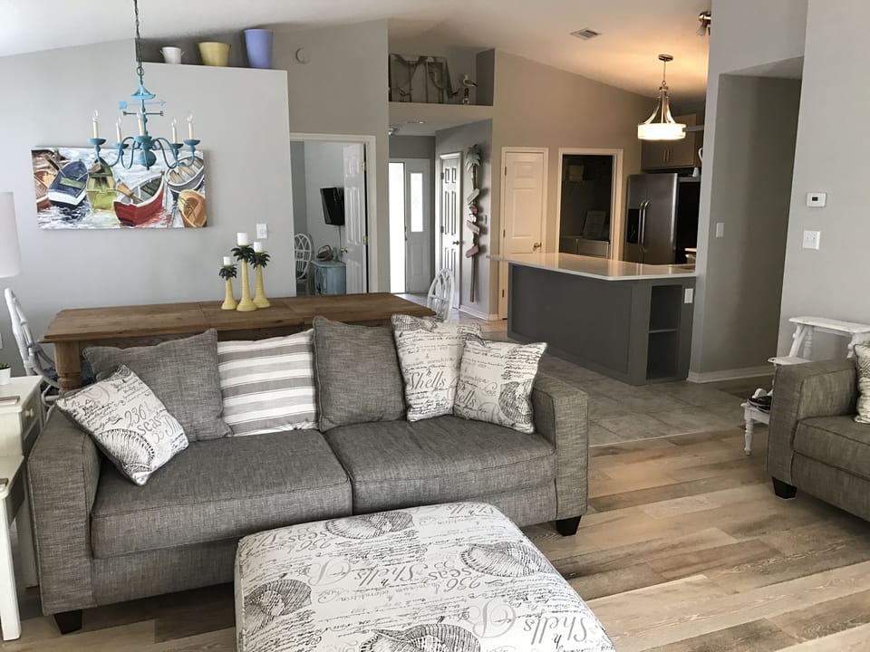 Living Room with 2 couches, Large Flat Screen TV & new hardwood floors!
