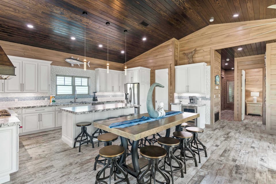 Large dining table ideal for shared meals under warm wood ceilings.