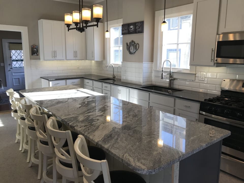 Large fully renovated kitchen with 11ft granite island and 6 stools. 