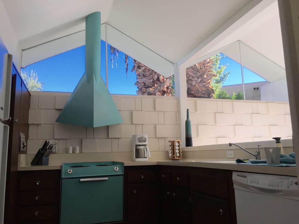 Kitchen with original custom teal stove/vent hood.  