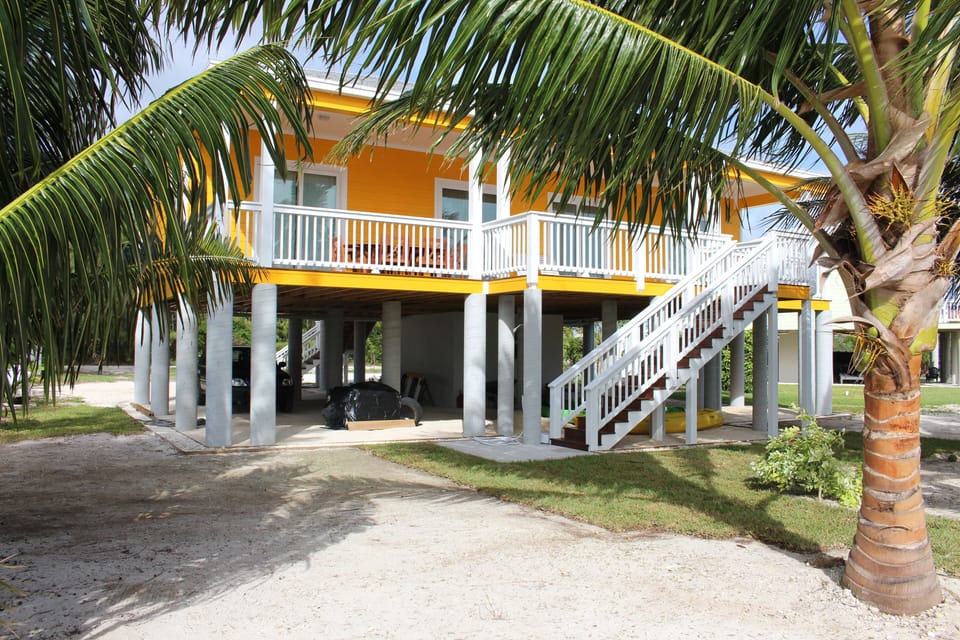 Entrance to the covered deck from the beach and outdoor shower.