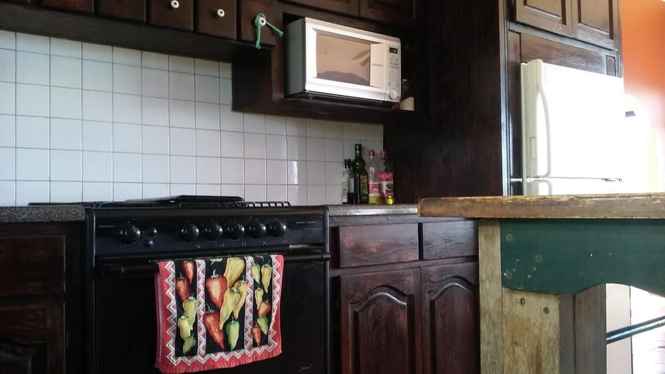 The kitchen is fully equipped, with an oven, stove, pots/pans, micro, and fridge