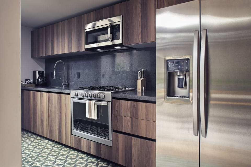 Design Suite, Multiple Beds, Non Smoking | Private kitchen | Coffee/tea maker, full-size fridge, microwave, oven
