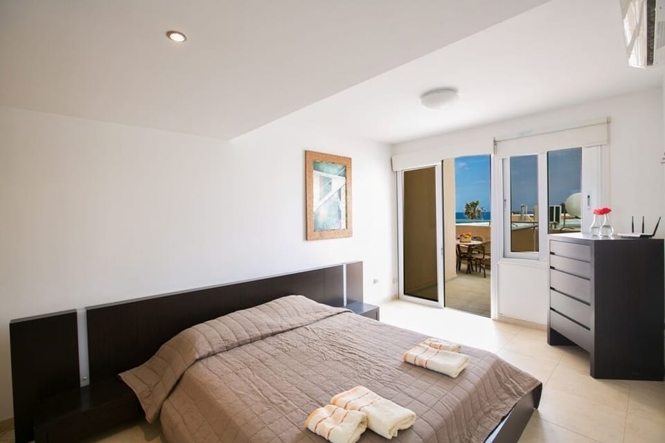 Bedroom 2 with double bed and balcony with seating area