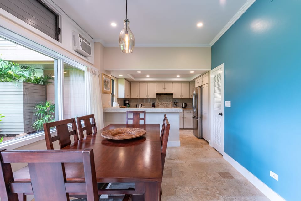 An inviting dining space with a stylish table and chairs, enhanced by air conditioning to ensure a cool and comfortable dining experience.