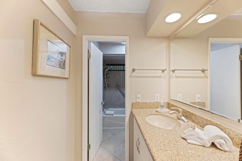 A door separates the shower and toilet from the rest of the bathroom, ensuring privacy and convenience.