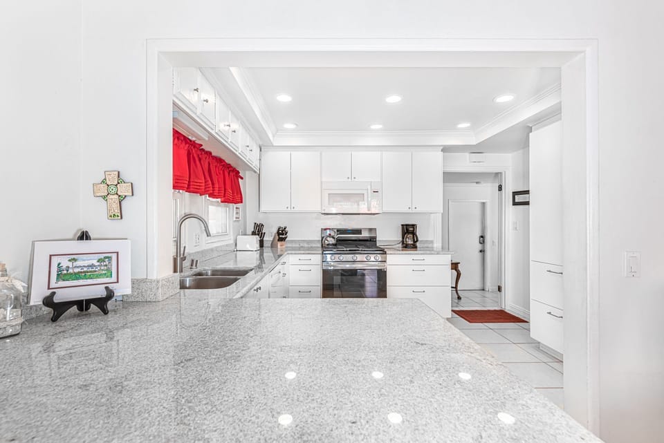 A breakfast bar with seating for two looks into the kitchen, making meal prep a social affair!
                