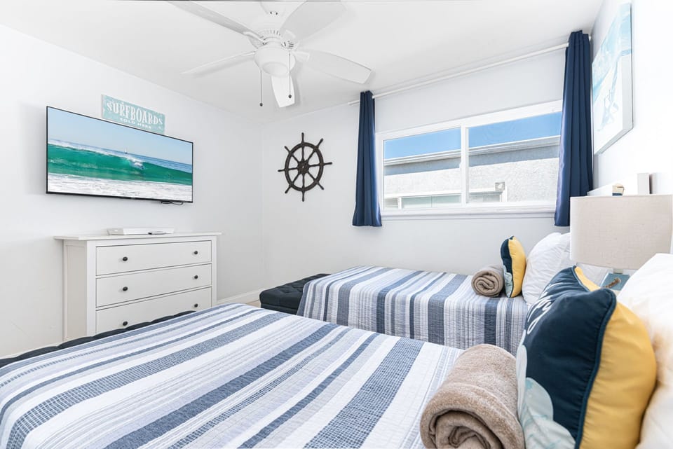 This twin bedroom offers a cheerful escape where children or additional guests can relax, recharge, and enjoy a restful night’s sleep
                