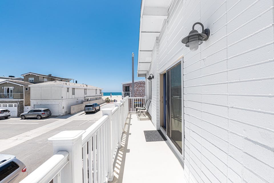 The front balcony includes chair seating, natural gas bbq grill, and views of the ocean!
                